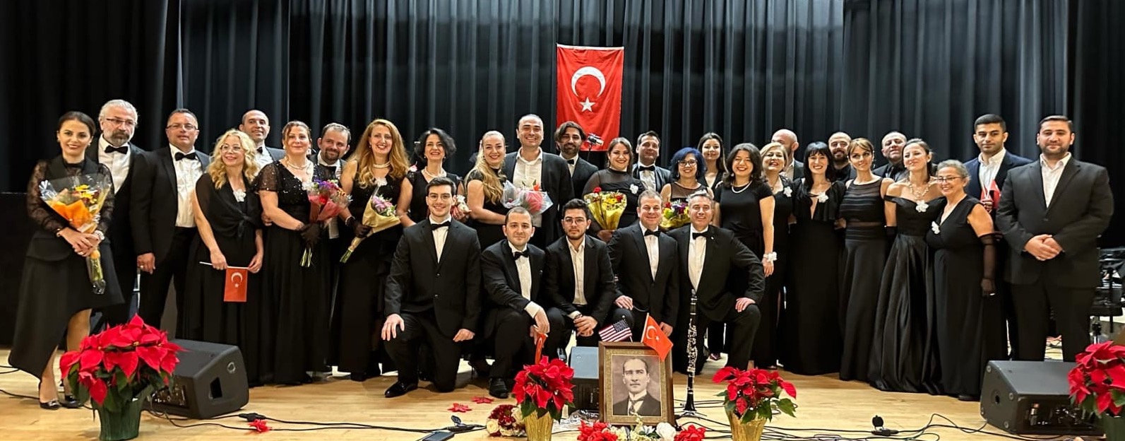 DMV Turkish Music Ensemble choir group photo with Turkish flag
